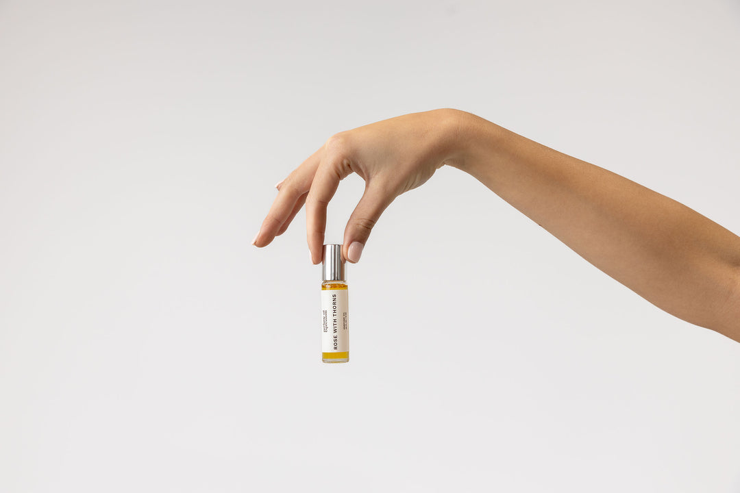 Holding Rose With Thorns Perfume Oil, a daring and elegant fragrance with notes of Bulgarian rose, turmeric, and patchouli, the best dupe for Rose Prick